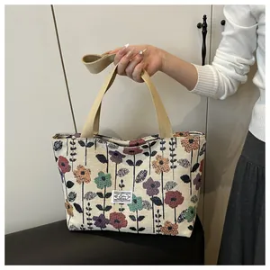 Close-up of vintage tapestry floral tote bag with embroidery label and woven handle