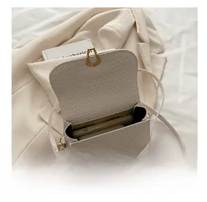 Detail view of woven texture crossbody bag interior showing phone and wallet capacity