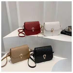 Close-up of woven texture handbags in multiple colors with golden U-shaped metal buckles