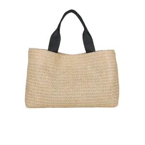 Straw tote bag with black textile handles and natural woven texture on white background