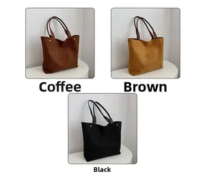 Three suede tote bags in coffee, brown, and black with leather handles and metal rivets