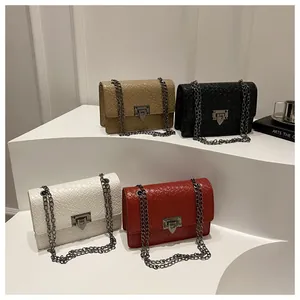 Close-up of four stylish stone pattern crossbody bags in white red khaki and black