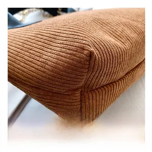 Detailed macro view of vintage brown corduroy fabric texture and reinforced corner stitching