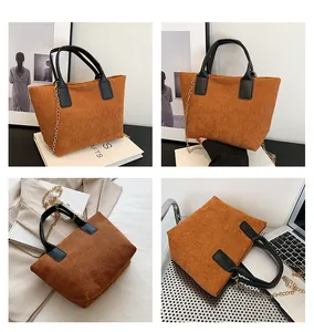 Brown corduroy tote bag detail showing textured fabric and leather handles