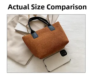 Size comparison of a brown corduroy tote bag showing leather handles and metal chain
