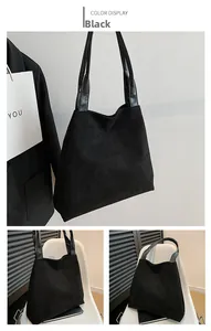 Detail of black faux suede tote bag with contrast smooth leather shoulder straps