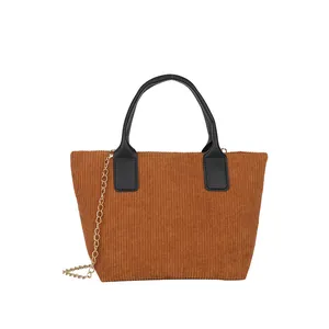 Brown corduroy tote bag with black leather handles and gold chain strap for daily wear
