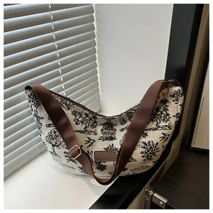 Detailed close-up of a moon bag with vintage Toile de Jouy print and wide strap