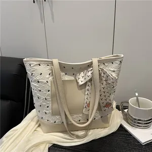 Pink quilted tote bag with leather拼接 details and decorative silk scarf for women