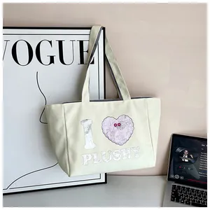 Detail of cream canvas tote bag featuring I Love Plushy art print and stylish design