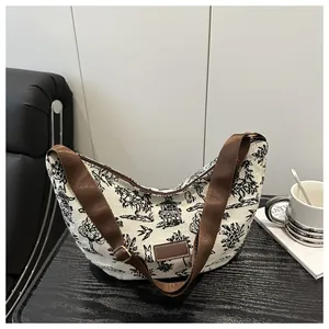 Detailed close-up of Toile de Jouy canvas tote bag with brown straps and leather patch