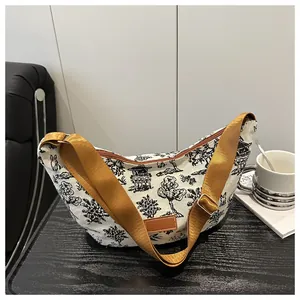 Detail of canvas tote bag with mountain landscape print and adjustable brown strap
