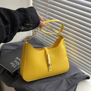 Minimalist yellow leather hobo bag with gold metal hardware and chain handle