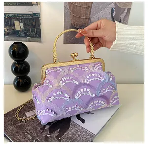 Close-up of purple sequin handbag featuring vintage gold floral handle and metal frame