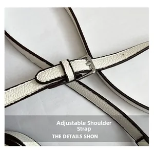 Detail view of white litchi grain leather strap with silver buckle and adjustable length