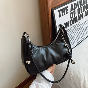 Dettaglio borsa hobo nera con cerniera a catena argentata e nodo decorativo in pelle liscia