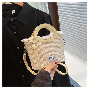 Straw basket bag with white lace trim, a cute bow, and yellow faux leather straps