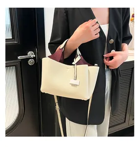 Close-up of cream pebble leather bucket bag featuring a contrasting burgundy interior