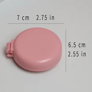 Kompakte rosa klappbare Reisehaarbürste mit Spiegel und Maßen von 7 cm und 6,5 cm