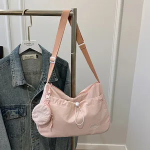 Pink large capacity nylon tote bag with pleated design and matching mini coin purse