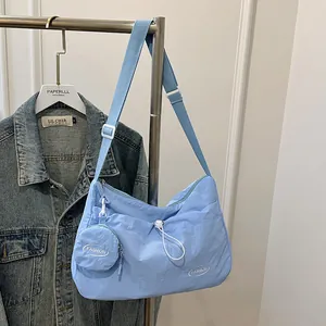 Light blue large canvas tote bag with pleated design and matching mini coin purse detail