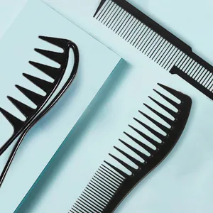 Detailed overhead view of professional black hair styling combs set on blue surface