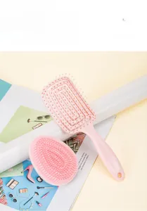 Portable pink detangling hair brush set including a vented comb and round handheld brush