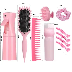 Pink hair care set detail showing spray bottle, hairbrushes, clips and silk scrunchie
