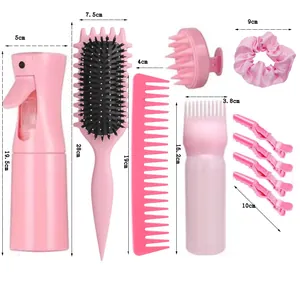 Pink hair care styling kit with detangling brush spray bottle and scalp massager
