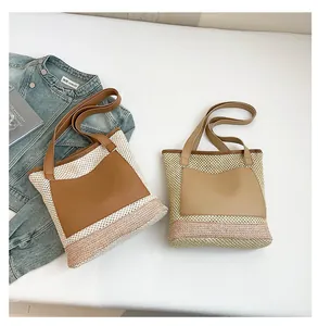 Close-up of straw woven tote bags with leather pockets and striped base details