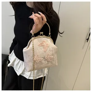 Detailed close-up of a vintage lace tote bag featuring 3D pink butterfly appliques