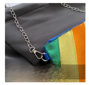 Close-up of durable silver metal hook and chain on rainbow textured crossbody bag