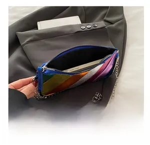 Detail view of rainbow striped metallic crossbody bag showing interior storage capacity