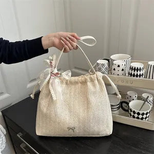 Chic woven straw beach tote bag with lace bow and floral embroidery details