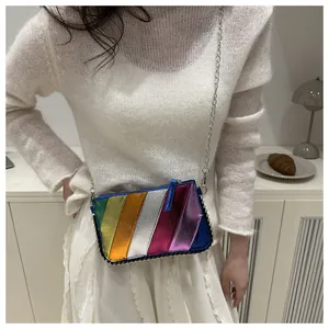 Detailed view of rainbow striped metallic leather crossbody bag with silver chain strap