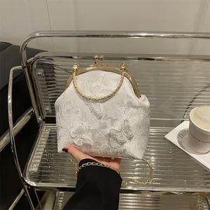 Elegant white lace tote bag with floral embroidery and gold metal ring handle