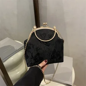 Elegant black velvet tote with gold butterfly embroidery and round metal top handles