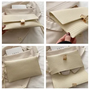 Detail of cream pleated envelope bag with gold geometric buckle and internal storage capacity