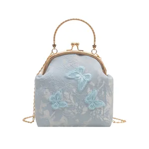 Light blue cheongsam style chain bag with butterfly embroidery and golden metal handle