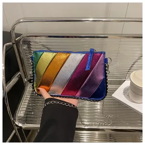 Detail of colorful rainbow crossbody bag with metallic texture and silver chain strap