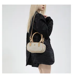 Side view of white woven crossbody pillow bag with leather trim and gold logo detail