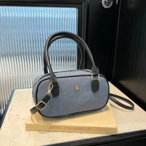 Chic grey checkered Boston bag with leather handles and gold logo on art books