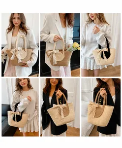 Detail view of woven straw tote bags featuring elegant lace bows and round top handles
