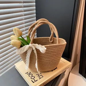 Handmade straw woven tote bag with lace bow decoration for beach vacations and daily use