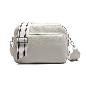White lychee pattern crossbody camera bag with adjustable striped wide fabric strap