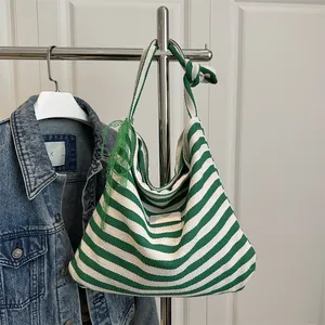 Fashionable green striped canvas tote bag with side lace bow decoration and long straps