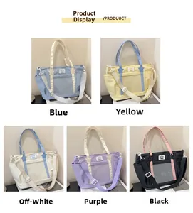 Detail view of colorful crossbody tote bags with star accents and transparent pockets