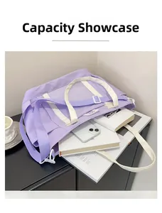 Capacity display of purple canvas tote bag showing interior space for books and phone
