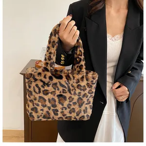 Detail of plush faux fur leopard print tote bag styled with a professional black blazer