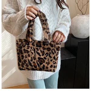 Detail view of a leopard print faux fur tote bag styled in a high-quality fashion setting